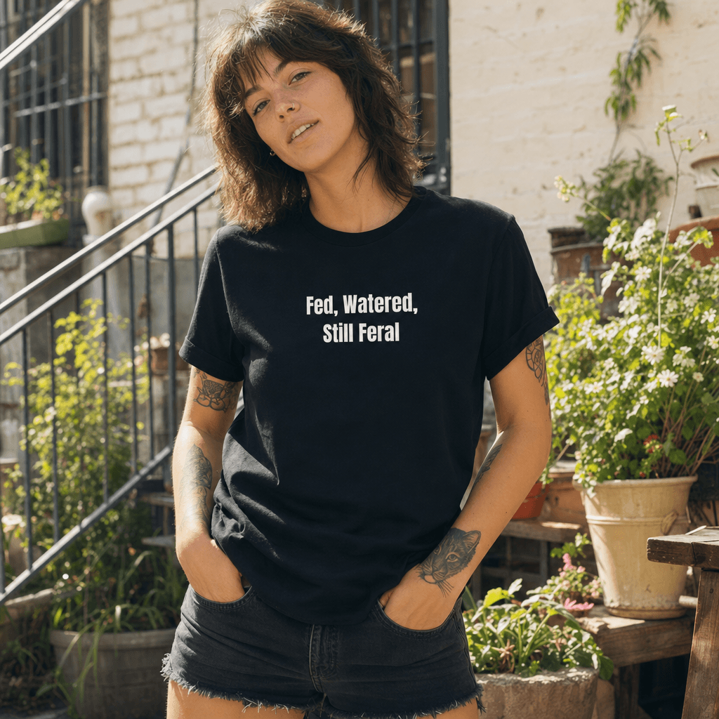 Fed, Watered, Still Feral graphic tee from the Feral Self-Care collection